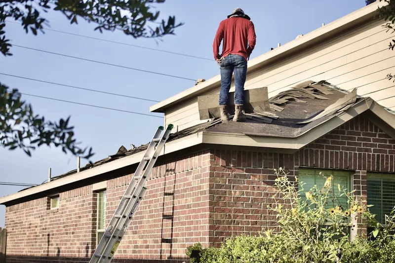 Professional roofer working on a residential roof in Baynard Village
